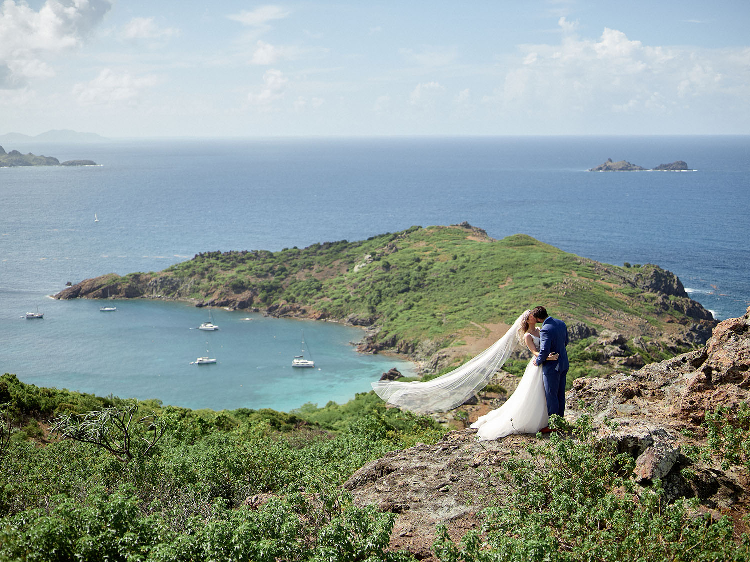 panoramic coastal view with bride and groom kissing